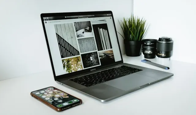 An overhead shot of a laptop and smartphone on a desk, representing a combined website and social media marketing strategy.